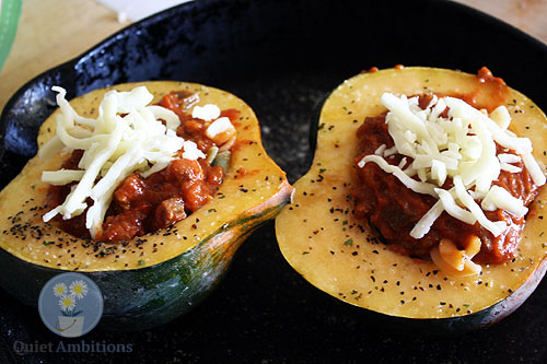 roasted acorn squash with sausage, tomato sauce and cheese.